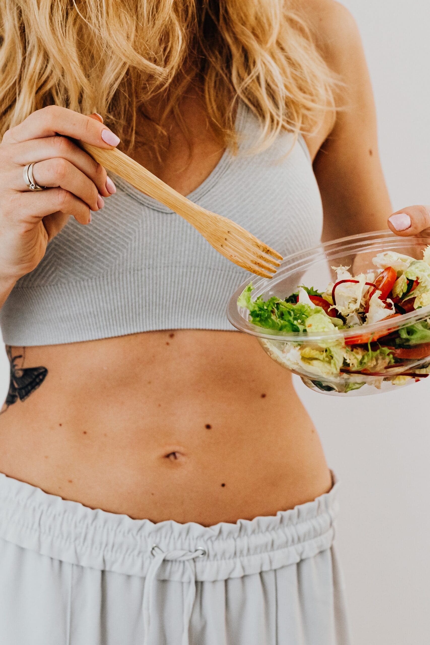 woman eating a high fiber plant-based meal with text overlay that reads what happens when you eat 25g of fiber a day